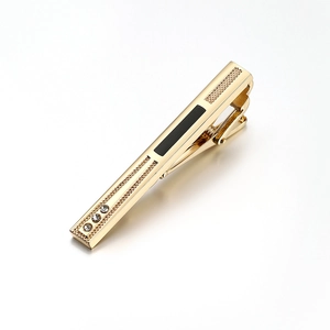 Elegant gold tie clip for men with black enamel inlay and three small sparkling crystals
