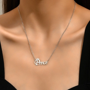 Minimalist Prince letter pendant necklace with crown detail worn on model neck