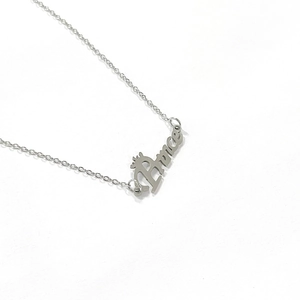 Macro view of silver stainless steel Prince pendant necklace with crown design detail