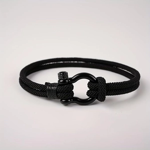 Handwoven black Milan rope bracelet with a metallic horseshoe buckle for men