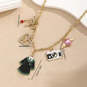 Detailed view of gold chain necklace with five unique enamel and gemstone pendants