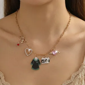 Close-up of a gold stainless steel necklace with ocean-themed pendants on model neck