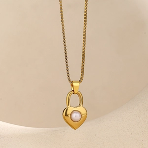 Detail der goldenen Box-Kette mit Herz-Medaillon-Anhänger und eingelegter Muschelperle