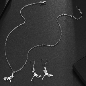 Stainless steel jewelry set featuring hollow dragonfly pendant necklace and earrings
