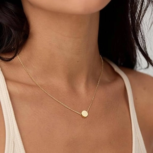Minimalist 8mm gold bead necklace in stainless steel shown on a model neck
