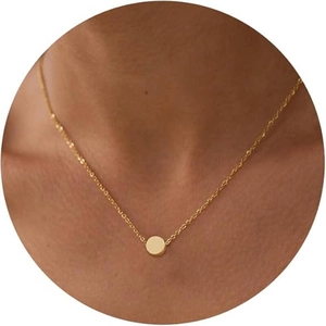 Close-up of minimalist 8mm gold round bead pendant on a delicate chain necklace