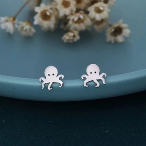 Cute octopus stainless steel stud earrings with polished silver finish on blue ceramic