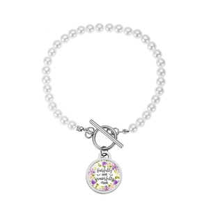 Handmade pearl bracelet with toggle clasp and floral pendant featuring text design