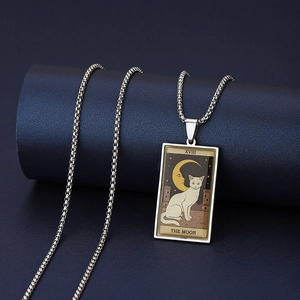 Macro shot of silver stainless steel Tarot Moon necklace with white cat and starry sky design
