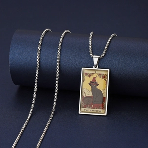 Macro shot of stainless steel The Magician tarot pendant featuring a black cat design