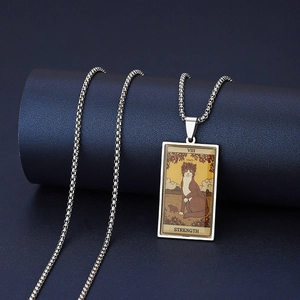 Macro shot of silver Strength VIII tarot pendant featuring a cat on a ball chain necklace