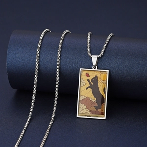 Close-up of The Fool Tarot cat pendant on a stainless steel box chain necklace