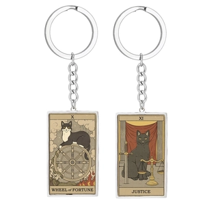 Macro view of Wheel of Fortune and Justice tarot cat stainless steel keychains