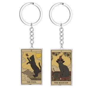 Retro black cat Tarot keychains showing The Fool and The Magician cards on white background