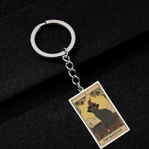 Detail of The Magician tarot keychain featuring a black cat and silver stainless steel ring