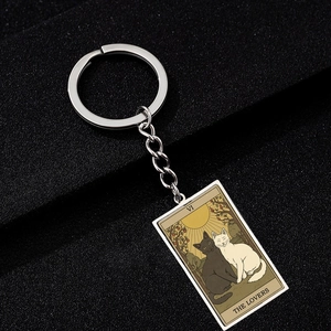 Detail of The Lovers tarot cat keychain in silver finish showing intricate cat artwork