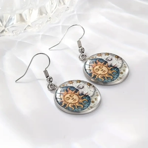Detailed shot of celestial sun and moon glass pendants on silk with elegant lighting