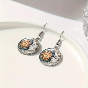 Detailed view of handmade glass dome earrings featuring celestial sun moon and stars