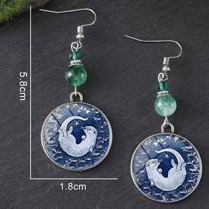 Boucles d'oreilles loutre en verre avec perles vertes et design attrape-rêves nuit étoilée