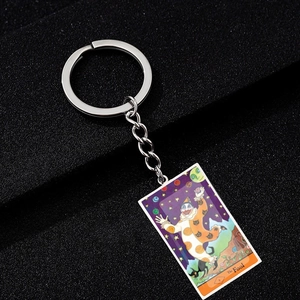 Detail of The Fool tarot card keychain with colorful enamel inlay and silver metal ring