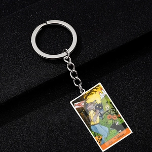 Macro view of Tarot The Moon pendant keychain with colorful Halloween pumpkin detail