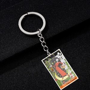 Macro detail of The High Priestess tarot card keychain with colorful enamel and metal ring