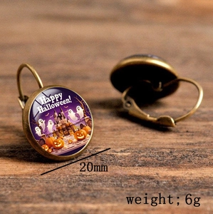 Detailed macro of vintage Halloween earrings showing ghost castle charms and 20mm diameter