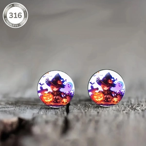 Macro view of 316 stainless steel earrings featuring witch and pumpkin Halloween motifs