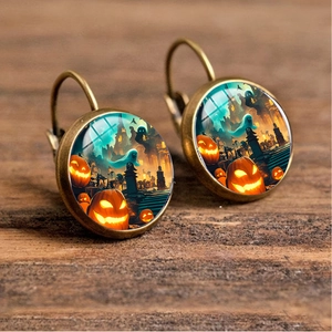 Detail of vintage bronze Halloween earrings featuring pumpkin and castle illustrations