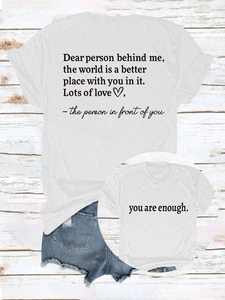 Flat lay of white cotton T-shirts for adults and kids with healing text prints