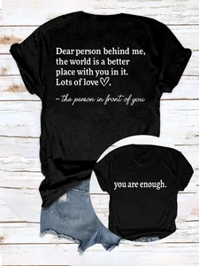 Detail of inspirational white text print on back of a black cotton casual t-shirt