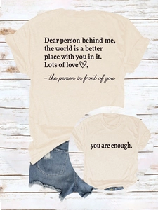 Detail showing 'you are enough' slogan and heart print on apricot cotton t-shirt