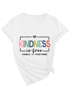 Detail of V-neck white tee featuring leopard heart print and Kindness Is Free slogan text
