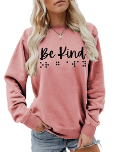 Detail of Be Kind text and braille dots print on casual pink long sleeve sweatshirt