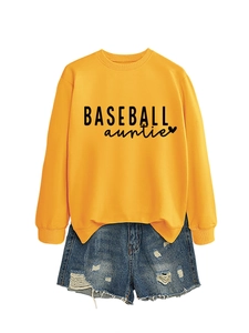 Detail of Baseball Auntie mustard yellow sweatshirt paired with distressed denim shorts