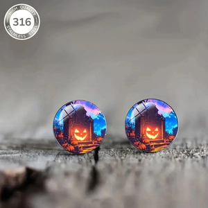 Detail of 316 stainless steel Halloween stud earrings featuring pumpkin and castle design