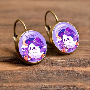 Detail of Halloween drop earrings featuring cute ghost with wizard hat on wood surface