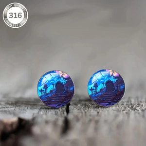Detailed macro view of 316 stainless steel stud earrings with Halloween graveyard art