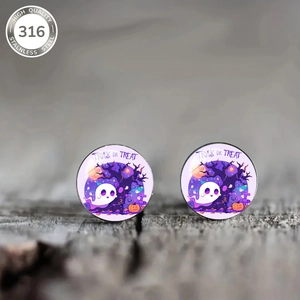 Macro shot of 316L stainless steel Halloween ghost studs with Trick or Treat design
