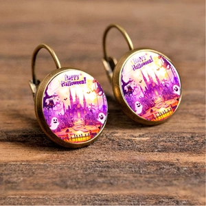 Detailed macro view of vintage bronze Halloween earrings with spooky castle artwork