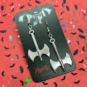 Gothic silver battle axe earrings on a black gargoyle card with bat background