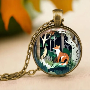 Artistic vintage necklace featuring a fox in the forest within a bronze circular frame