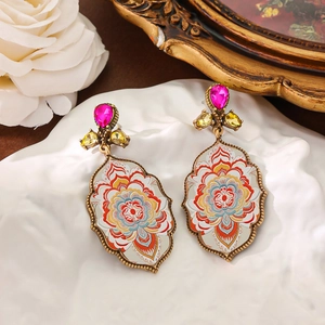 Vintage medieval mandala floral drop earrings with red gemstones in a gold frame