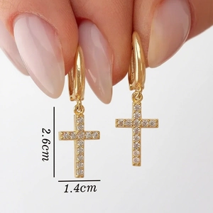 Detailed view of gold cross earrings with zircon pavé showing 2.6cm drop length