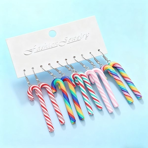 Five pairs of colorful candy cane resin drop earrings on white display cards