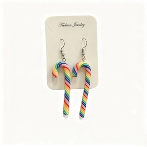 Close-up of rainbow polymer clay candy cane earrings on a white display card