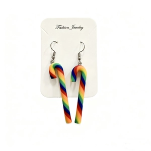 Detailed close-up of rainbow candy cane clay earrings on fashion jewelry card
