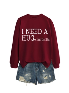 Detail of burgundy sweatshirt with white text and distressed denim shorts with frayed edges