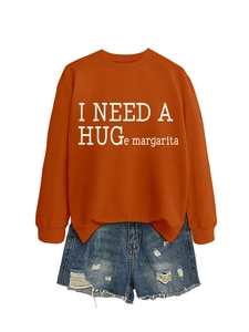 Detail of orange crewneck sweatshirt featuring white I NEED A HUGe margarita slogan print