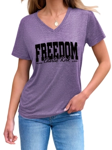 Detail shot of purple V-neck t-shirt with Freedom Charlie Kirk print and soft texture